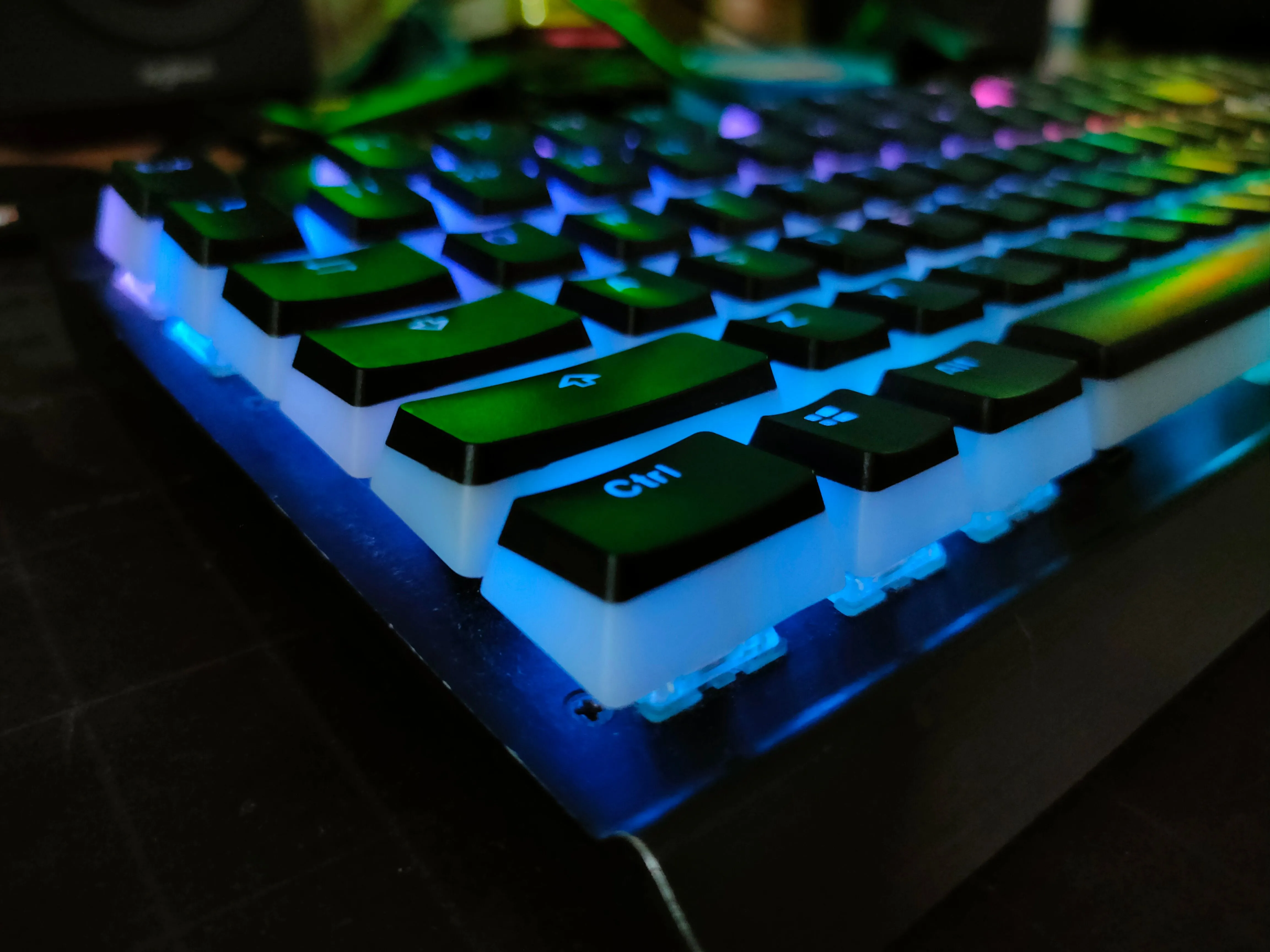 Bàn phím cơ Corsair K70 với đèn RGB nổi bật trong bóng tối, minh họa cho bàn phím có dây cồng kềnh, không tiện dụng cho việc đặt lên đùi.
