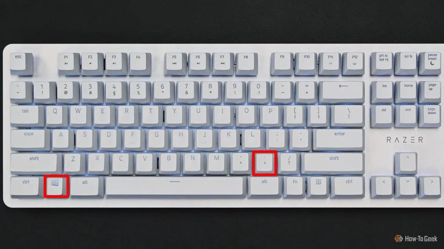 Bàn phím trắng với phím Meta (Windows) và dấu chấm được tô đỏ, minh họa phím tắt để mở trình chọn biểu tượng cảm xúc trong KDE Plasma.
