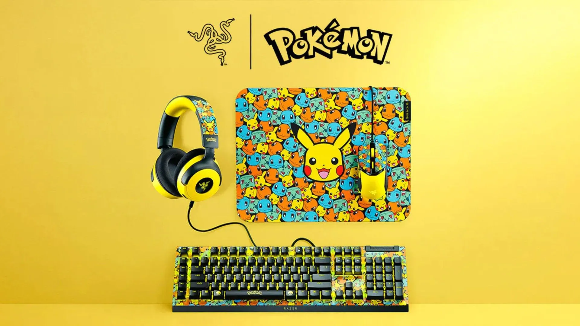Bộ phụ kiện chơi game Razer Pokémon Collection bao gồm bàn phím, chuột, và tấm lót chuột với thiết kế lấy cảm hứng từ Pokémon trên nền vàng.