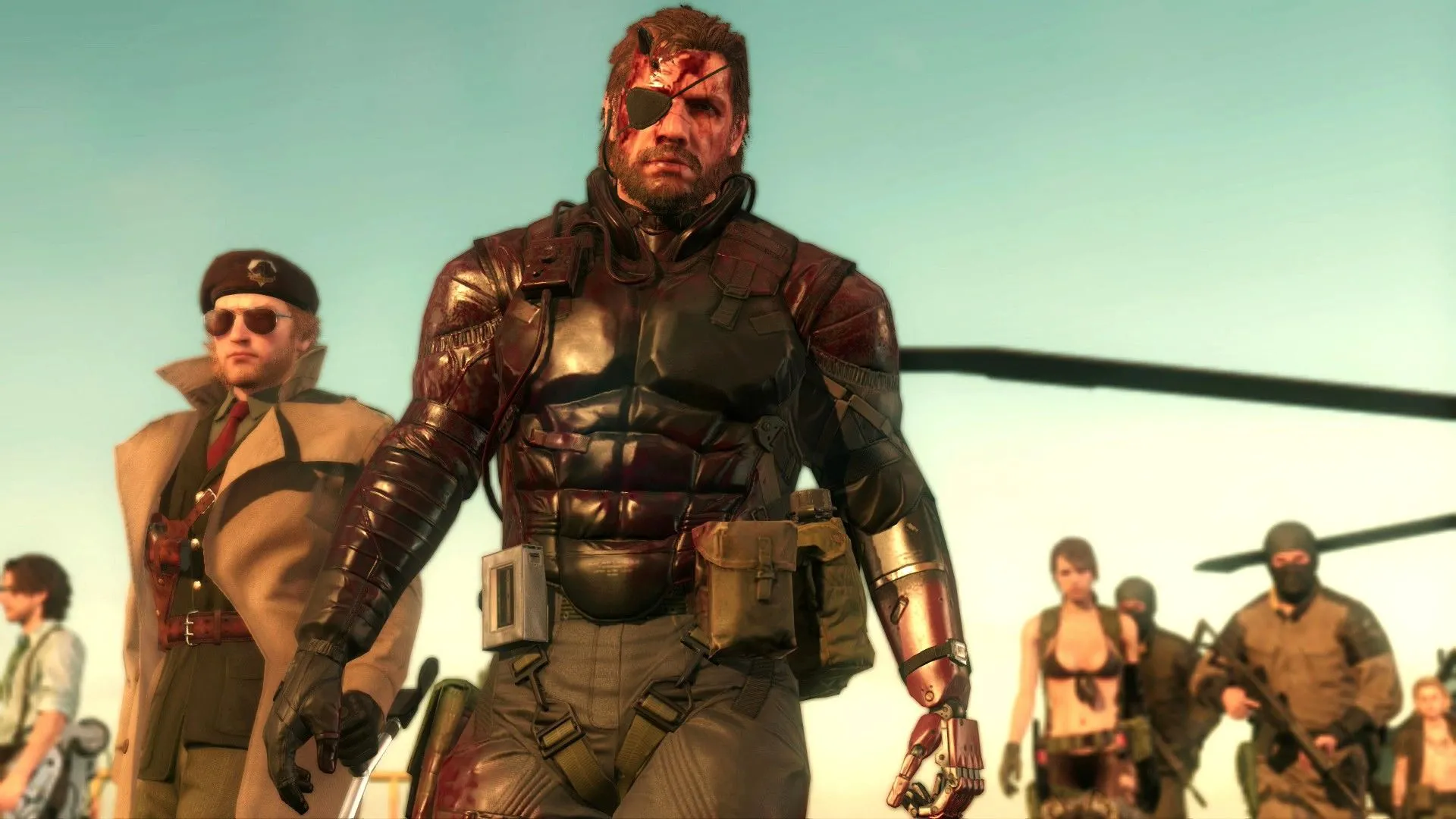 Huey Emmerich, Kazuhira Miller, Venom Snake, Quiet cùng các binh sĩ đang xem màn hình trong Metal Gear Solid V Phantom Pains, phản ánh cốt truyện gián điệp, chính trị rối rắm của series.